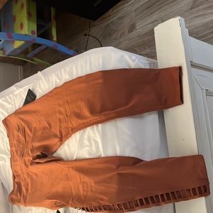 Orange/brown Nike workout leggings. Capri style. Size L. Never been worn
